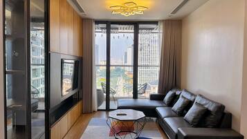 Standard Apartment, 3 Bedrooms | Living area | 65-inch flat-screen TV with satellite channels, fireplace