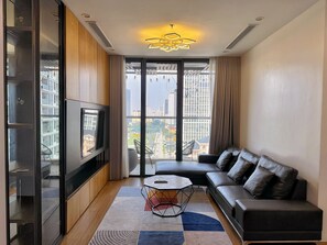 Standard Apartment, 3 Bedrooms | Living area | 65-inch flat-screen TV with satellite channels, fireplace - Mira Housing- Vinhome Skylake Luxury Apartment  (Hanoi)