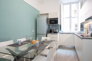 A compact kitchen with a refrigerator, microwave, and coffee maker.