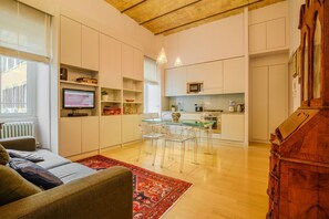 A modern apartment with a living area, kitchen, and dining space.