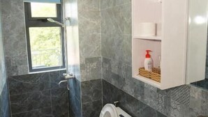 A bathroom with a toilet, sink, and shower. - Seimy Homestay (Da Nang)