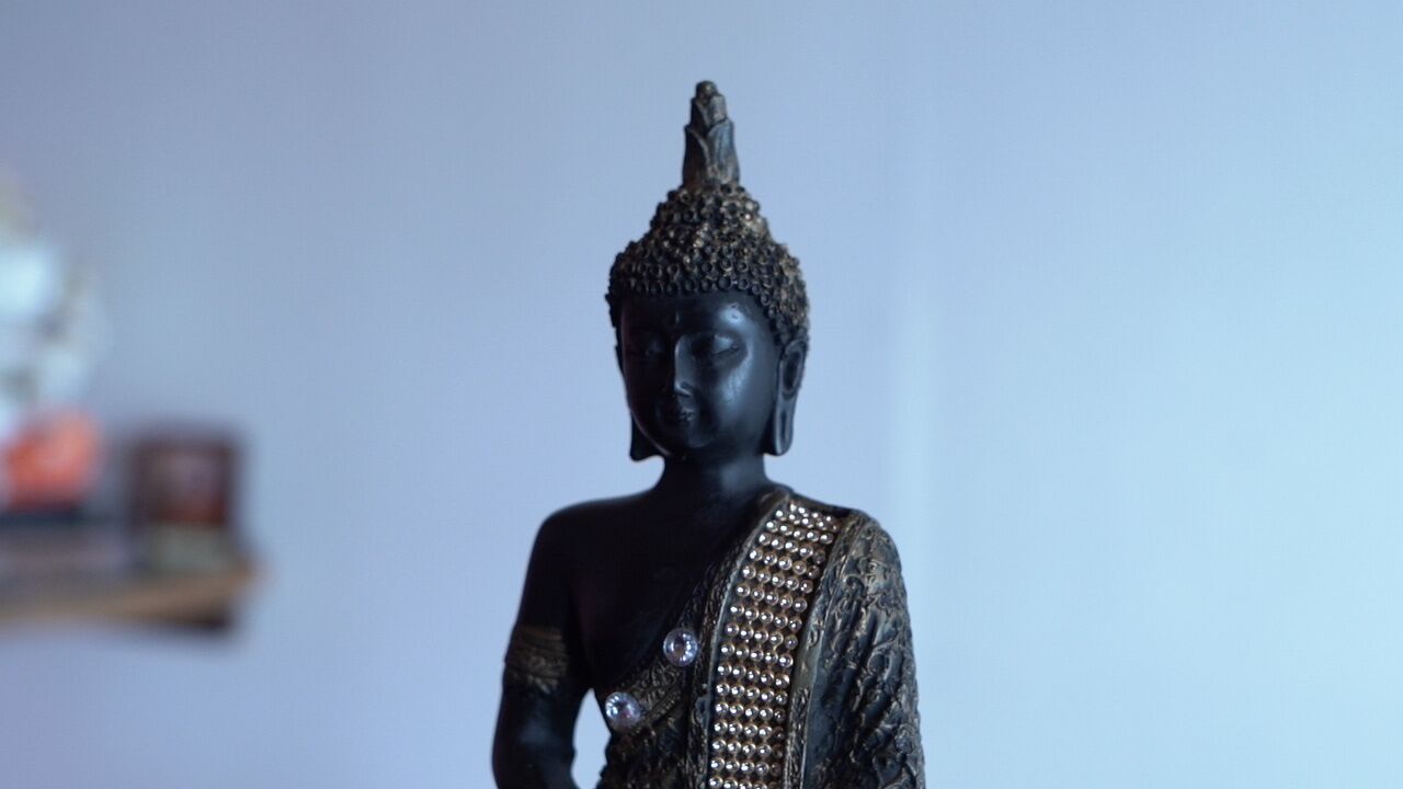 A statue with a detailed headdress and ornate attire.