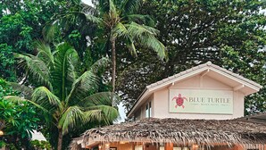 A beach hotel named Blue Turtle with a thatched roof and a signboard. - Blue Turtle Hotel Samui (Koh Samui)