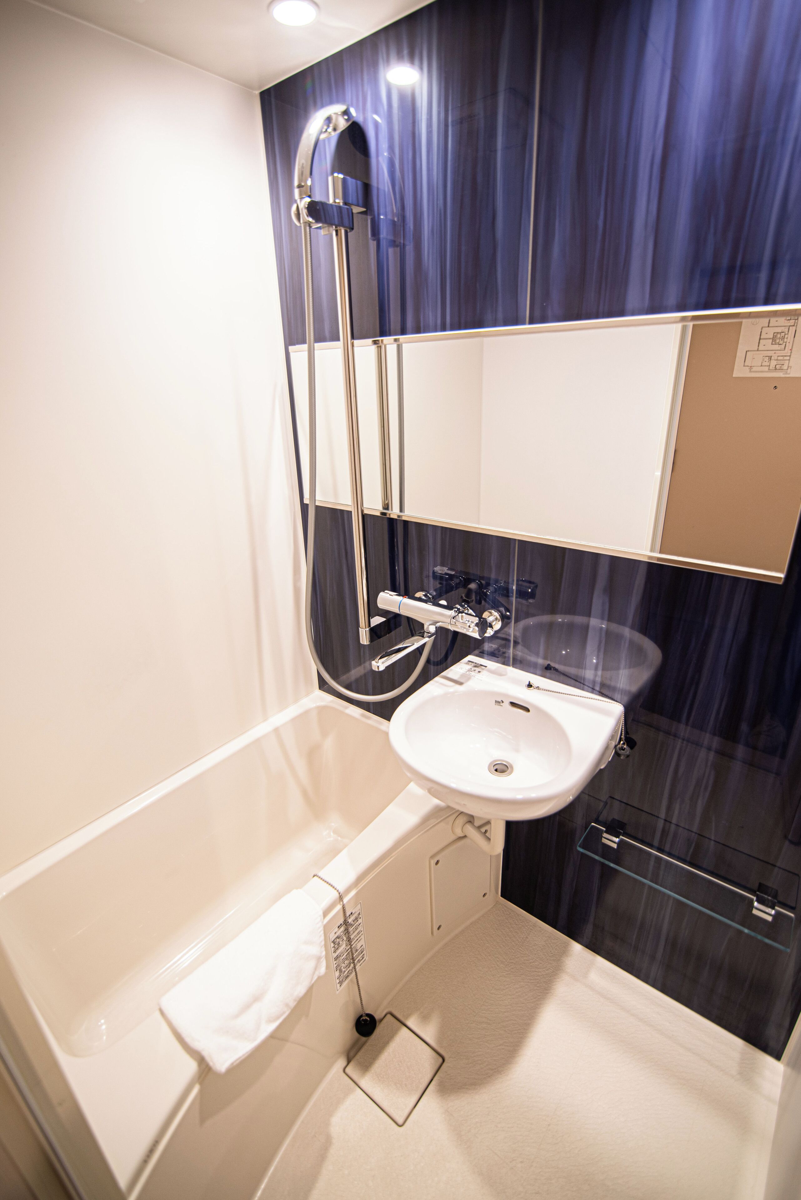 A modern bathroom with a bathtub, a sink, and a shower.