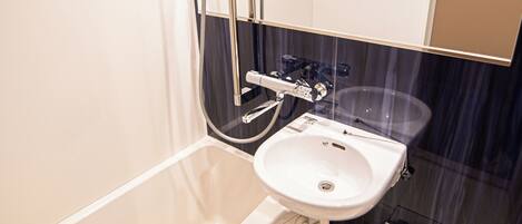 A modern bathroom with a bathtub, a sink, and a shower.