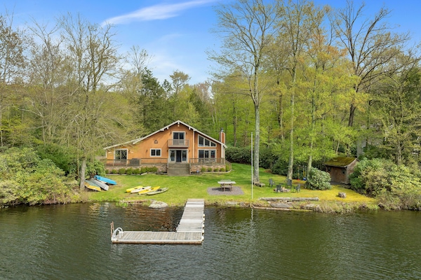 View of the Secluded Lakefront Escape from the lake. Big deck, lots of loungers in the yard.