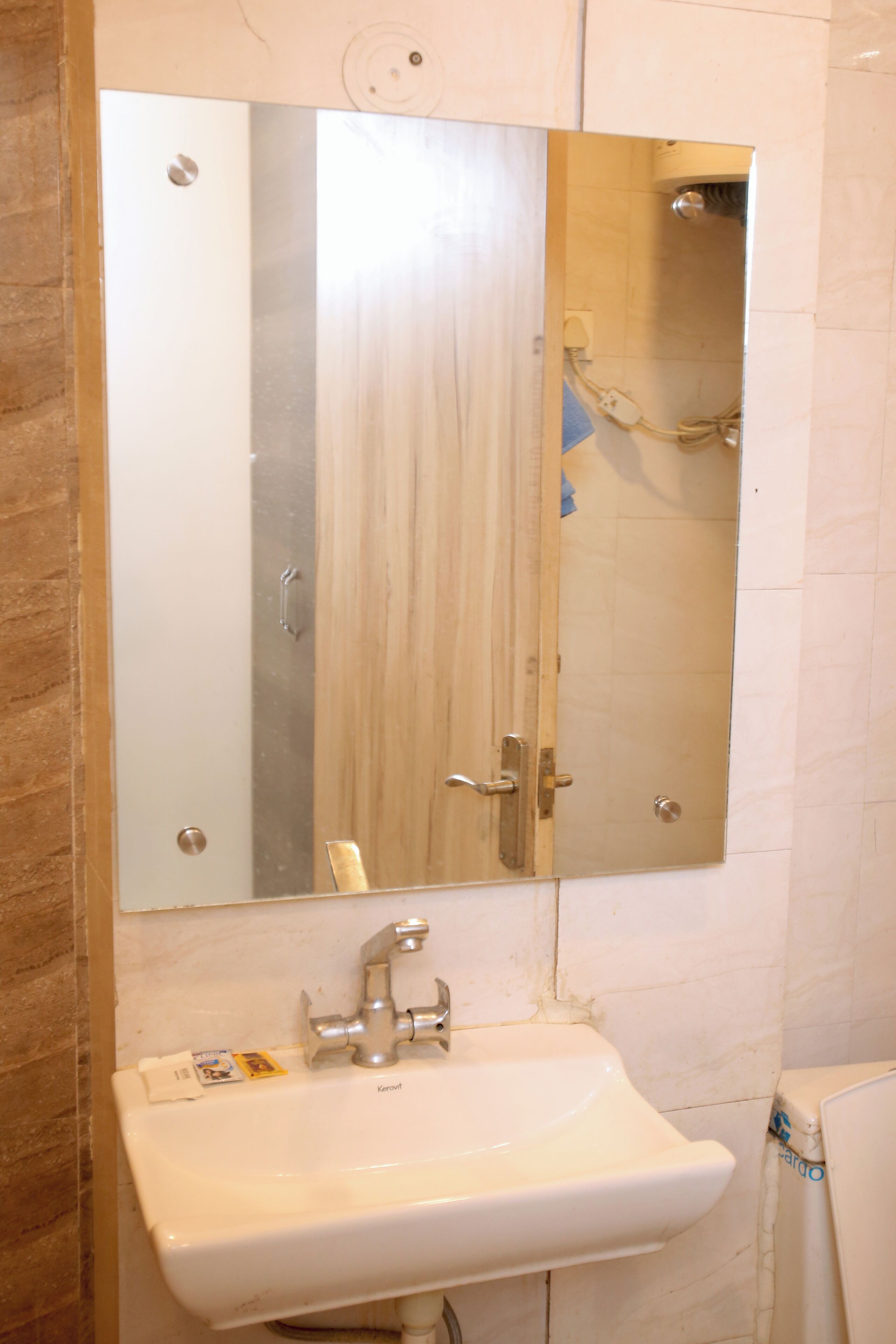 A bathroom with a white sink, a mirror, and a shower.