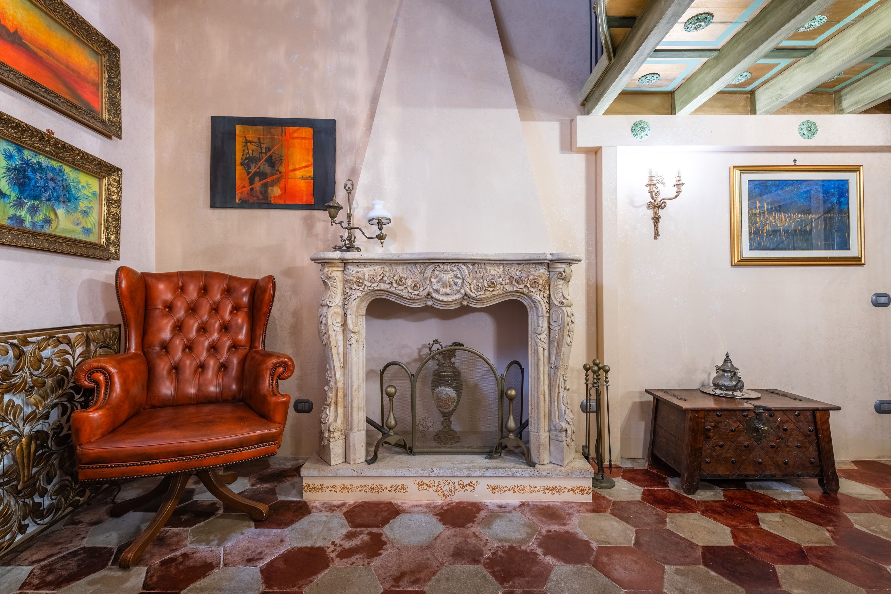 A room with a fireplace, a leather armchair, and a small wooden table.