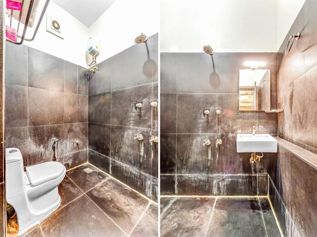 A bathroom with a shower, toilet, and sink.