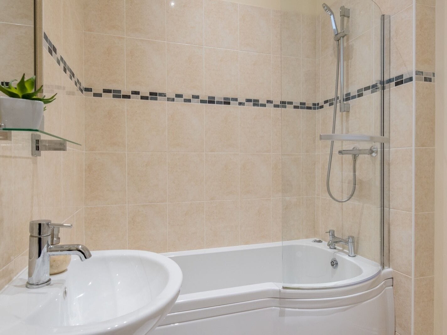 A bathroom with a bathtub, a sink, and a shower.