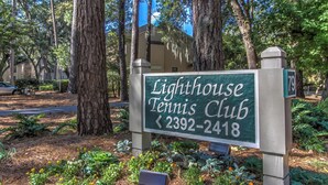 A sign for Lighthouse Tennis Club with a phone number. - 2382 Lighthouse Tennis: 1 Bedroom Pet Friendly, Free Bikes, Pool, Tennis (Hilton Head Island)