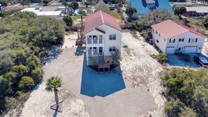 A coastal property with a large building featuring a red roof, a smaller adjacent building, and a beach view. - Family-Friendly w/ Private Pool, Gulf Views, Dogs OK! (St. George Island)