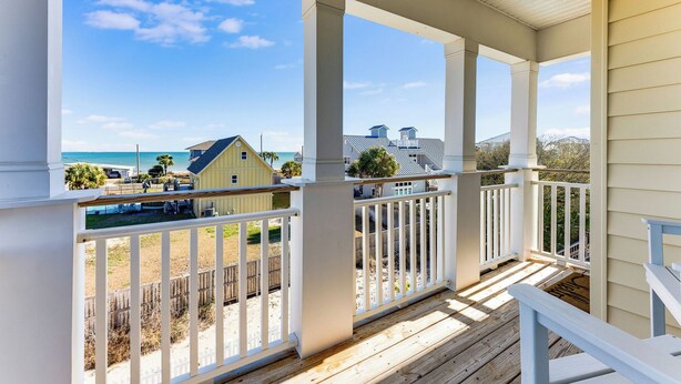 A covered porch with white railings and a view of the beach and ocean. - Family-Friendly w/ Private Pool, Gulf Views, Dogs OK! (St. George Island)
