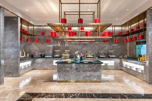 A modern interior with a marble floor, a central island with glass display, and red accents on shelves.