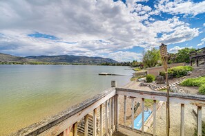 A lakeside view with a wooden deck, a small boat, and a gazebo. - Lakefront Oroville Paradise: Private Beach & Dock! (Oroville)