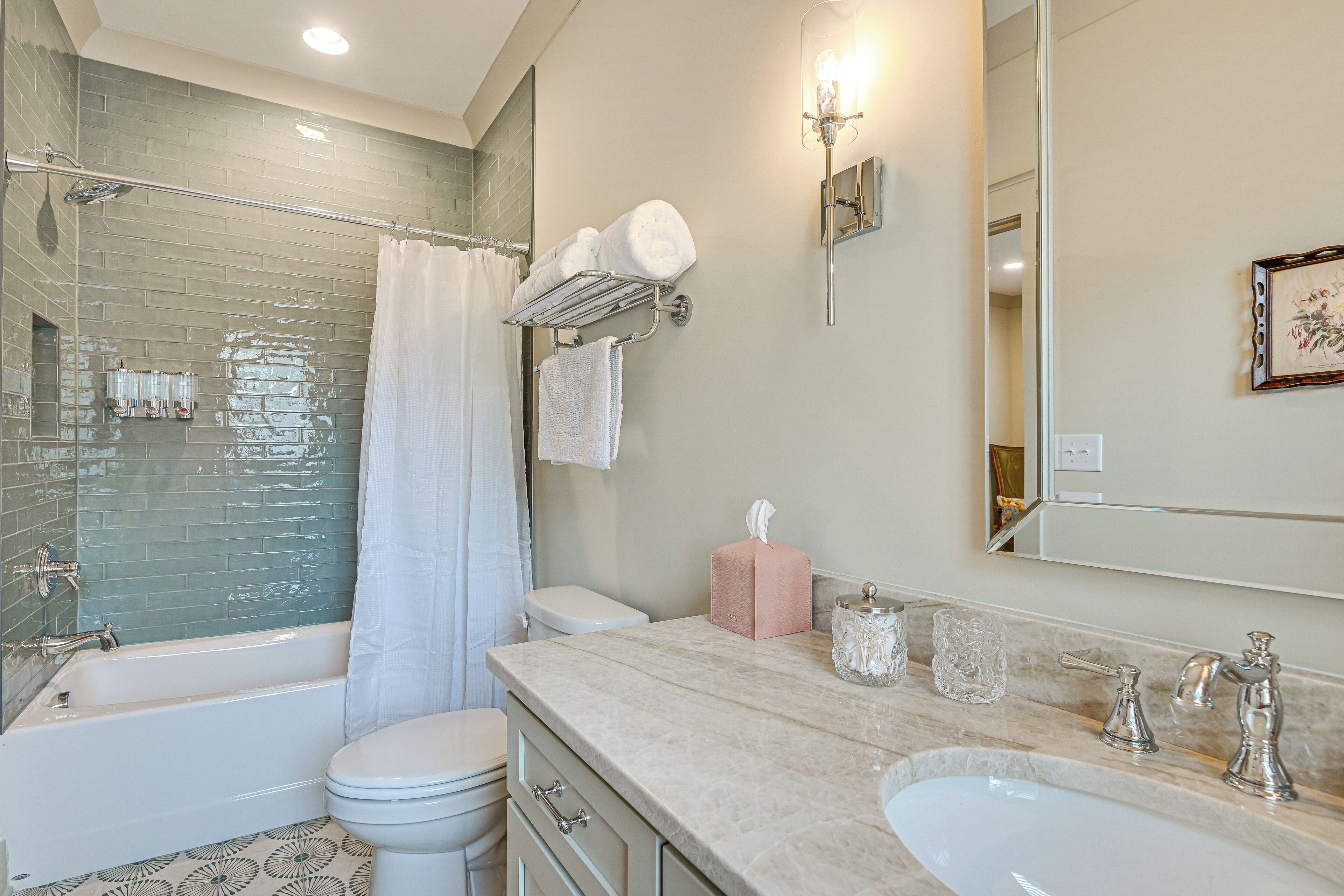 A bathroom with a bathtub, toilet, and sink.