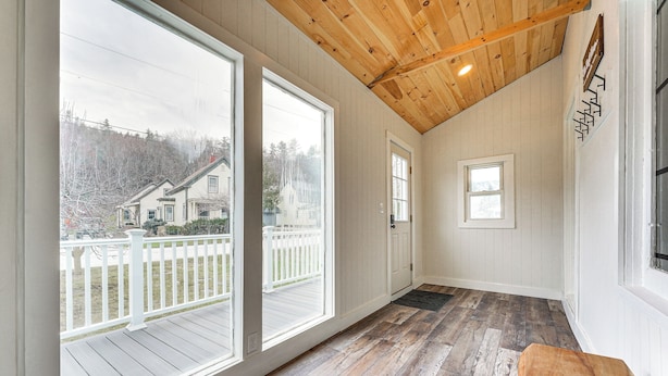 A spacious room with large windows, wooden flooring, and a high ceiling. - Lovely Ludlow Farmhouse ~ 1 Mi to Town & Slopes! (Ludlow)