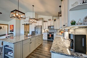 A modern kitchen with granite countertops, stainless steel appliances, and pendant lighting. - Mount Oxford Home w/Starlink & outdoor patio (Buena Vista)