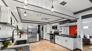 A modern kitchen with white cabinets, stainless steel appliances, and a central island. - 30% Off September, Great 4 Families -Pool, Jacuzzi (Palm Springs)