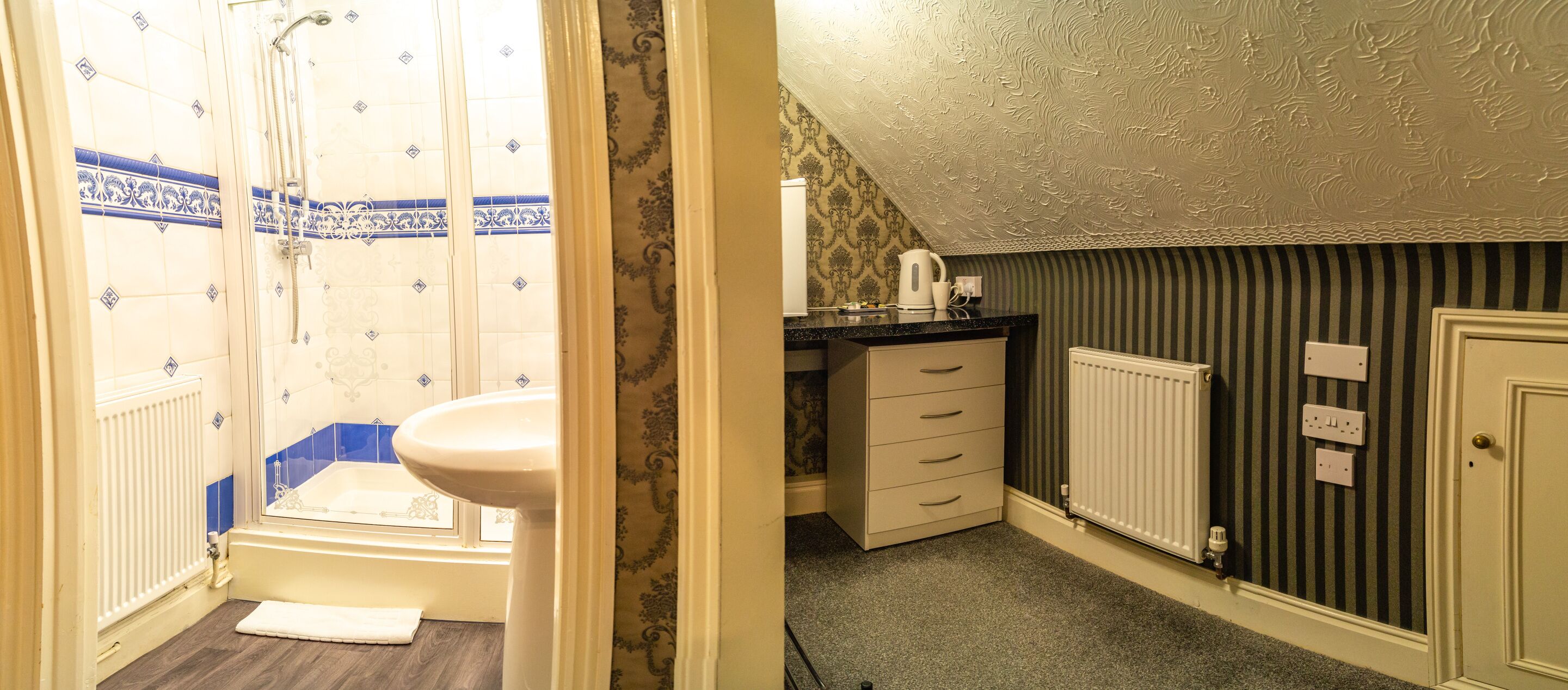 A bathroom with a shower, toilet, and sink. There is a radiator on the wall and a door with a handle.