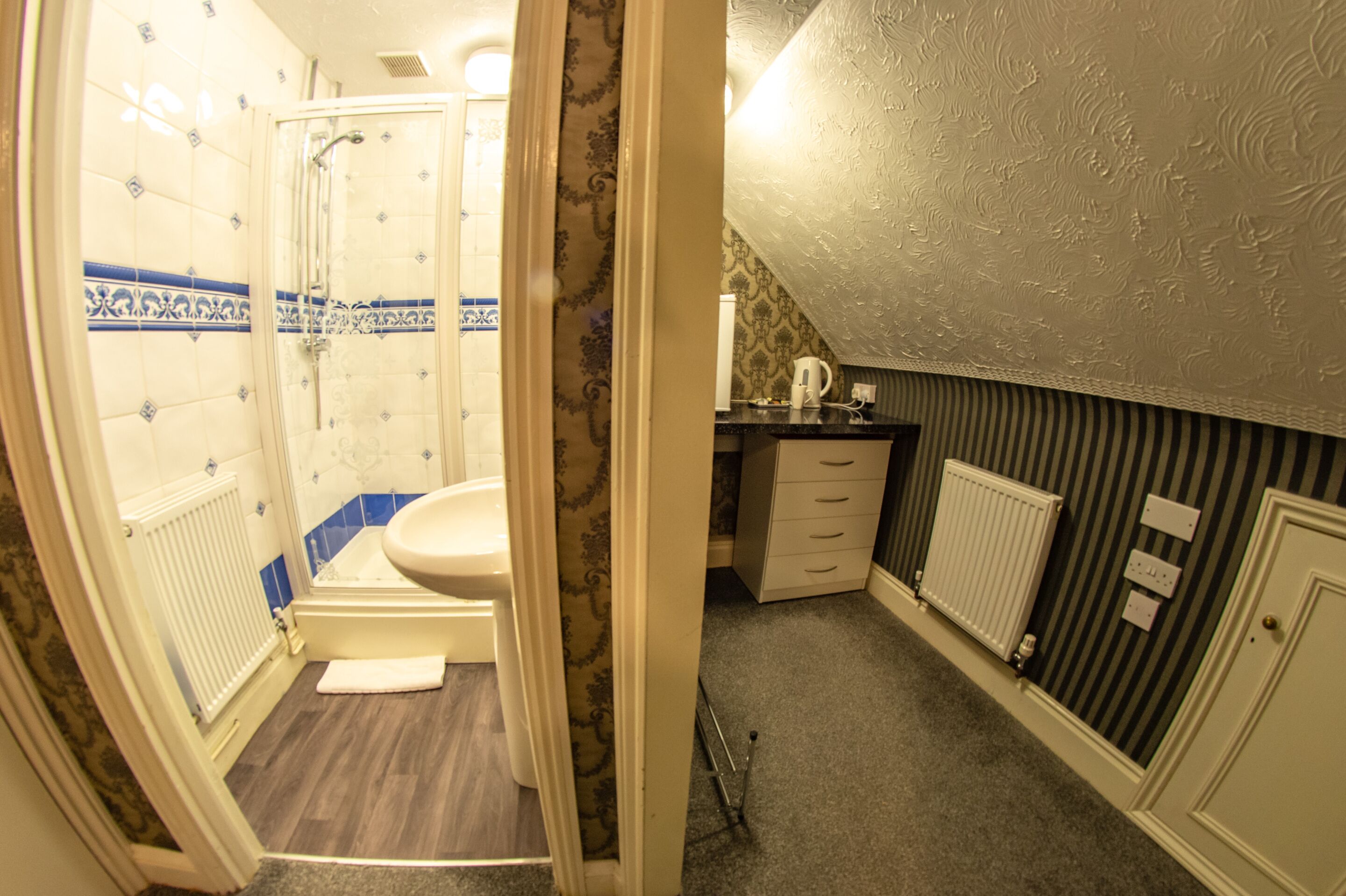 A bathroom with a shower, toilet, and a sink.