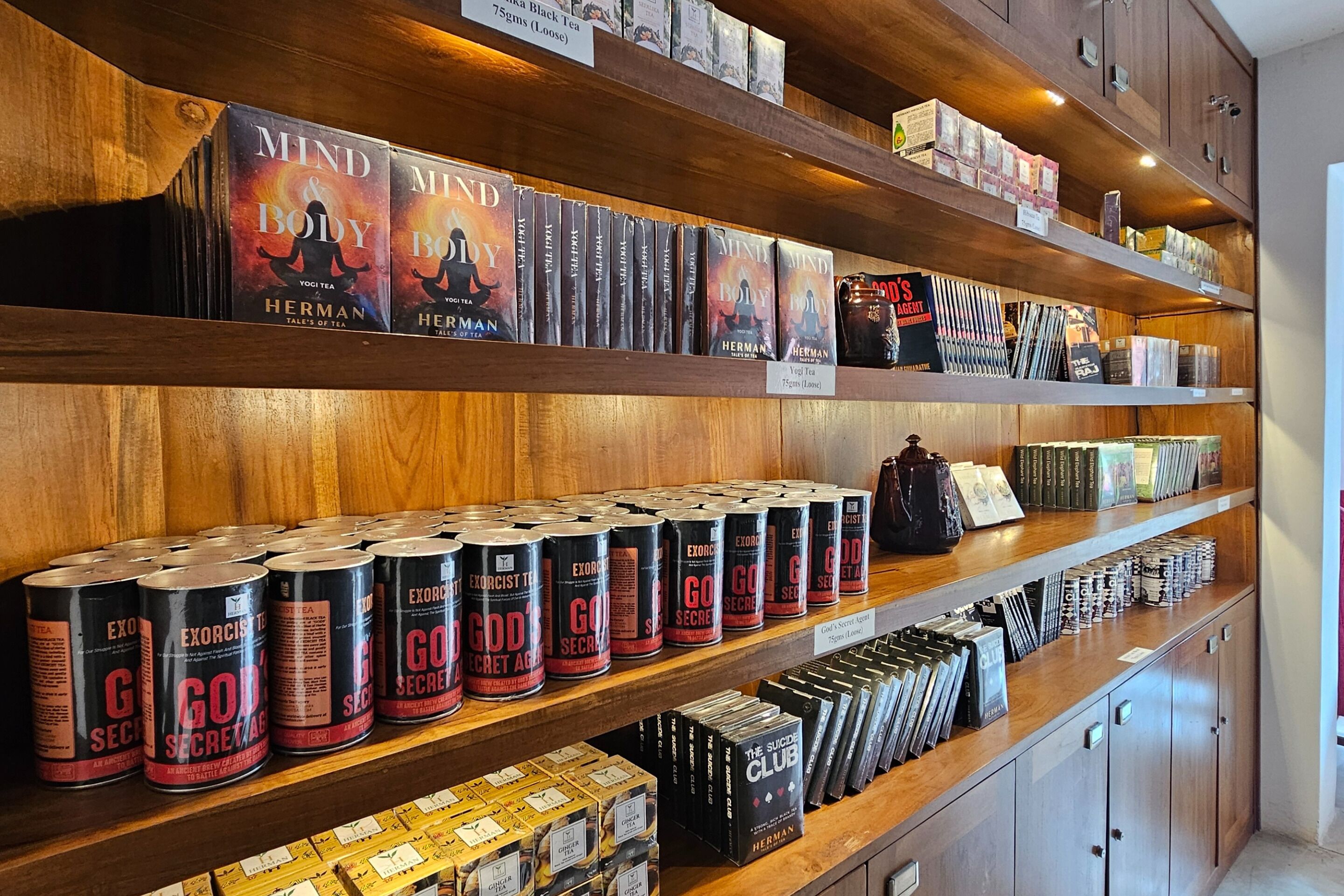 A bookstore with shelves stocked with books and tea products.