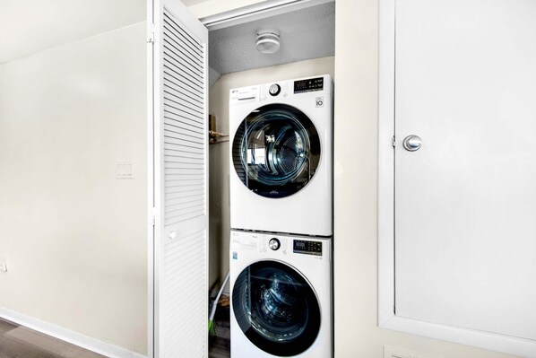 Efficient laundry facilities feature two front-loading washing machines with digital displays.