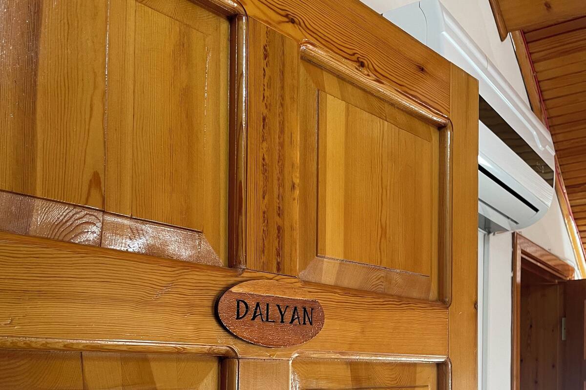 A wooden door with a sign that reads "DALYAN".