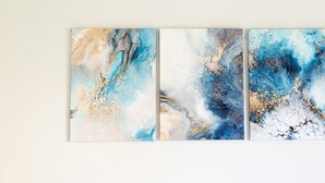 Three abstract paintings on a wall. - Alessandrino Apartment (Rome)