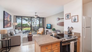 A modern apartment with a kitchen, dining area, and living room. - Perfect location in Kihei! 5 minutes to the beach! (Kihei)