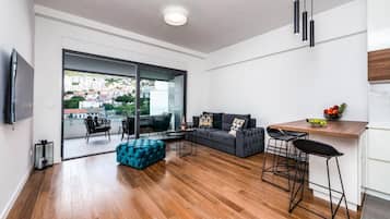 Apartment (One Bedroom Apartment with Balcony) | Living room | Flat-screen TV