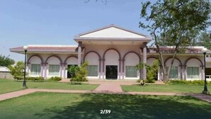 A building with a symmetrical facade, multiple arches, and a central entrance. - Dabchick Tourist Resort (Hodal)