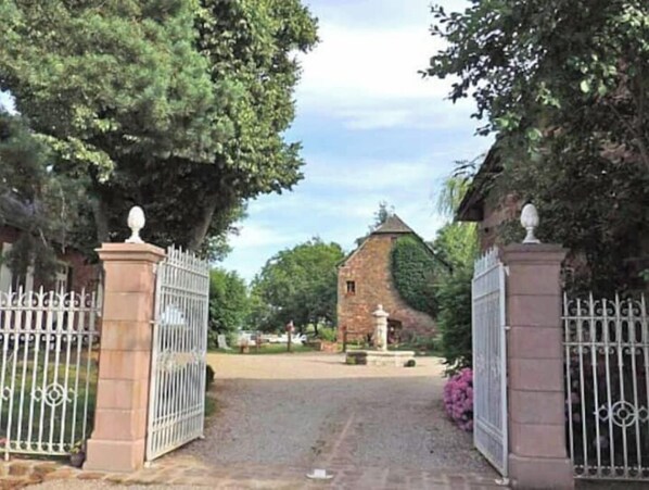 Enter a tranquil oasis surrounded by lush greenery and traditional architecture.