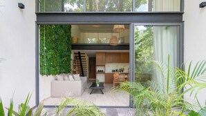 A modern interior with a living area, kitchen, and dining space. - Moderno Loft Temple II A112 By Sandy Powerful (Tulum)
