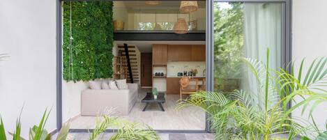 A modern interior with a living area, kitchen, and dining space.