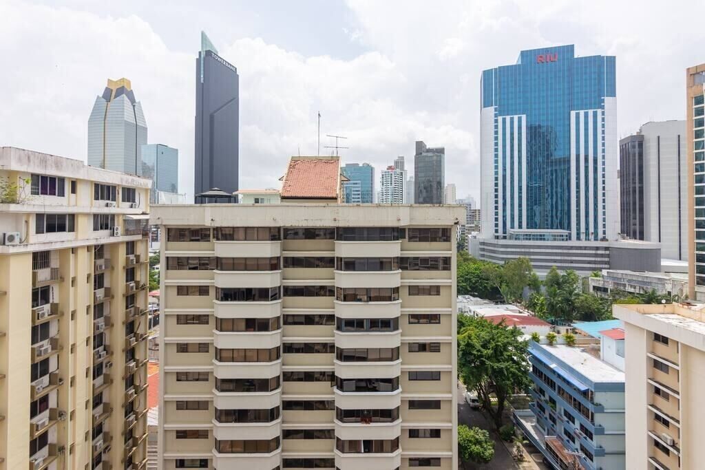 A high-rise building with multiple balconies and a modern architectural design.
