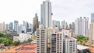 A high-rise building with a modern design, surrounded by other tall buildings in a cityscape.