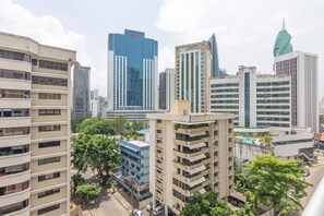 Un paisaje urbano con modernos rascacielos, incluyendo un edificio distintivo con forma de hoja.