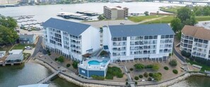 A modern hotel with a pool, waterfront location, and multiple buildings. - Next door to Dog Days Grill! Waterfront with amazing views! JACUZZI TUB (Osage Beach)