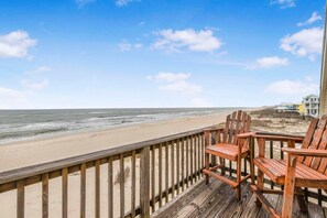 A wooden deck with chairs overlooking a beach. - Haven Harbor (Gulf Shores)