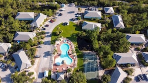 An aerial view of a residential area with houses, a swimming pool, and tennis courts. - The Rookery 2202 (Gulf Shores)