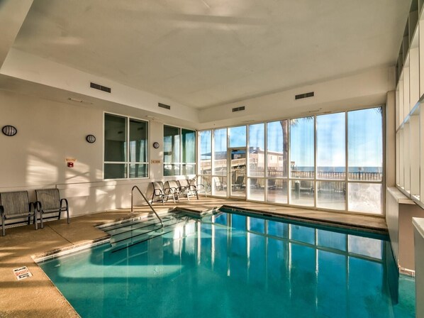 Relax by the pool with a view of the ocean and beach.