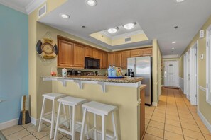 Enjoy cooking in this well-equipped kitchen with a central island and barstools.