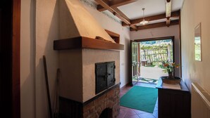 A kitchen with a brick oven, wooden beams, and a green mat leading to a garden. - A cozy and luxurious house with a pool beneath mount Donačka gora. (Rogatec)