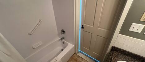 A bathroom with a bathtub, toilet, and sink.