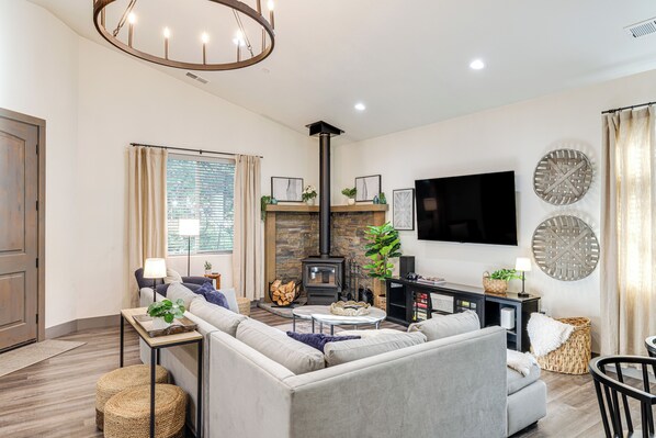 A modern living room with a fireplace, sofa, and television. - Game Room & Patio: Picturesque Home in Sonora (Sonora)