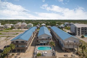 A resort with multiple buildings, a swimming pool, and a parking area. - Gulf View 16 (Gulf Shores)