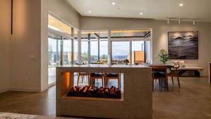 A modern kitchen with a central island, large windows, and a fireplace. - Glacier in Horizon by Yosemite (Midpines)