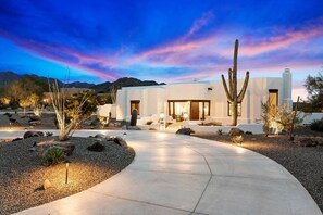 A modern house with a concrete pathway leading to the entrance, surrounded by desert landscaping and cacti. - Luxury Scottsdale Retreat w/Pool and Amazing Views (Scottsdale)