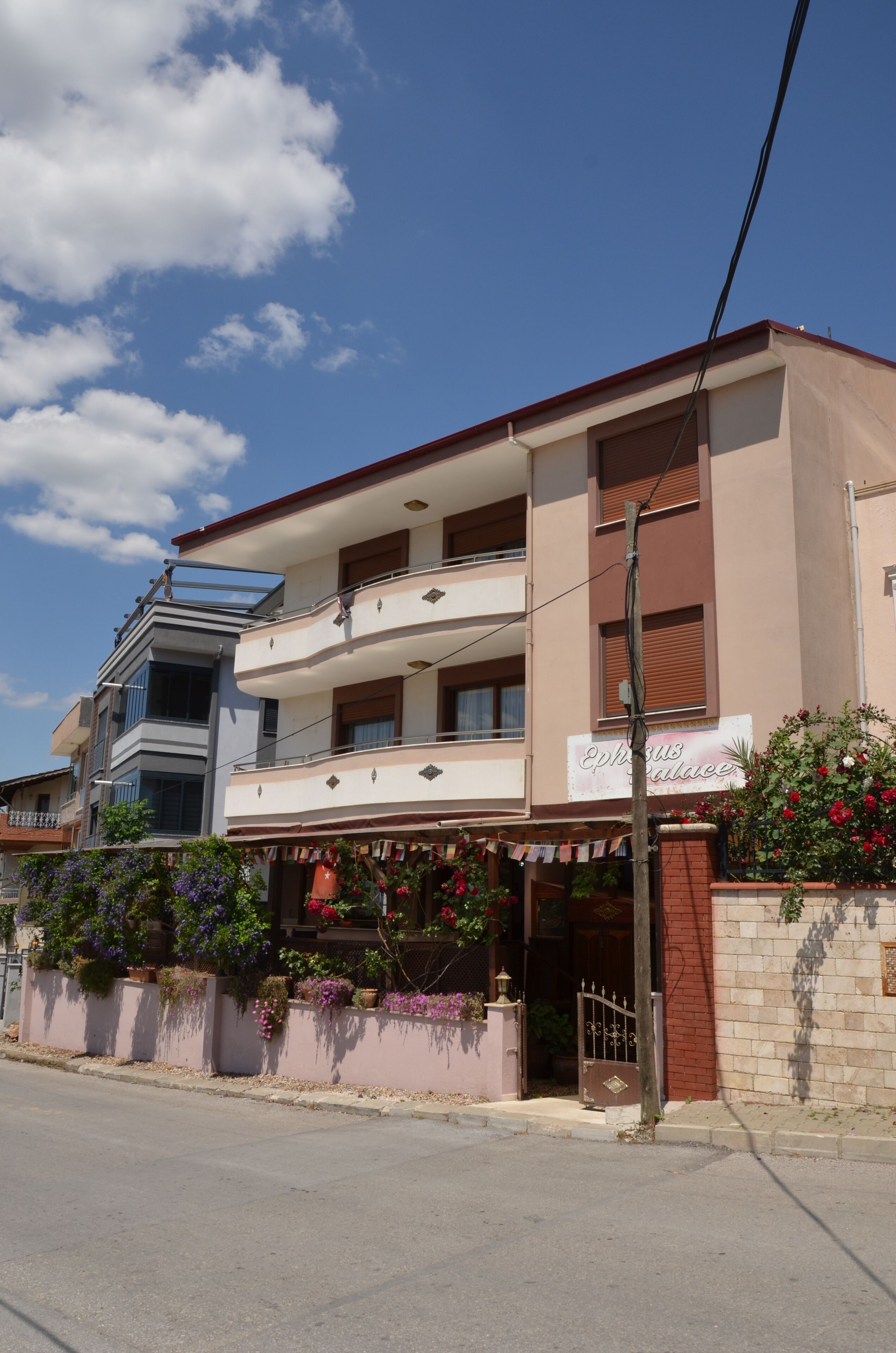 A two-story building with a sign reading "Ephorus Palace".